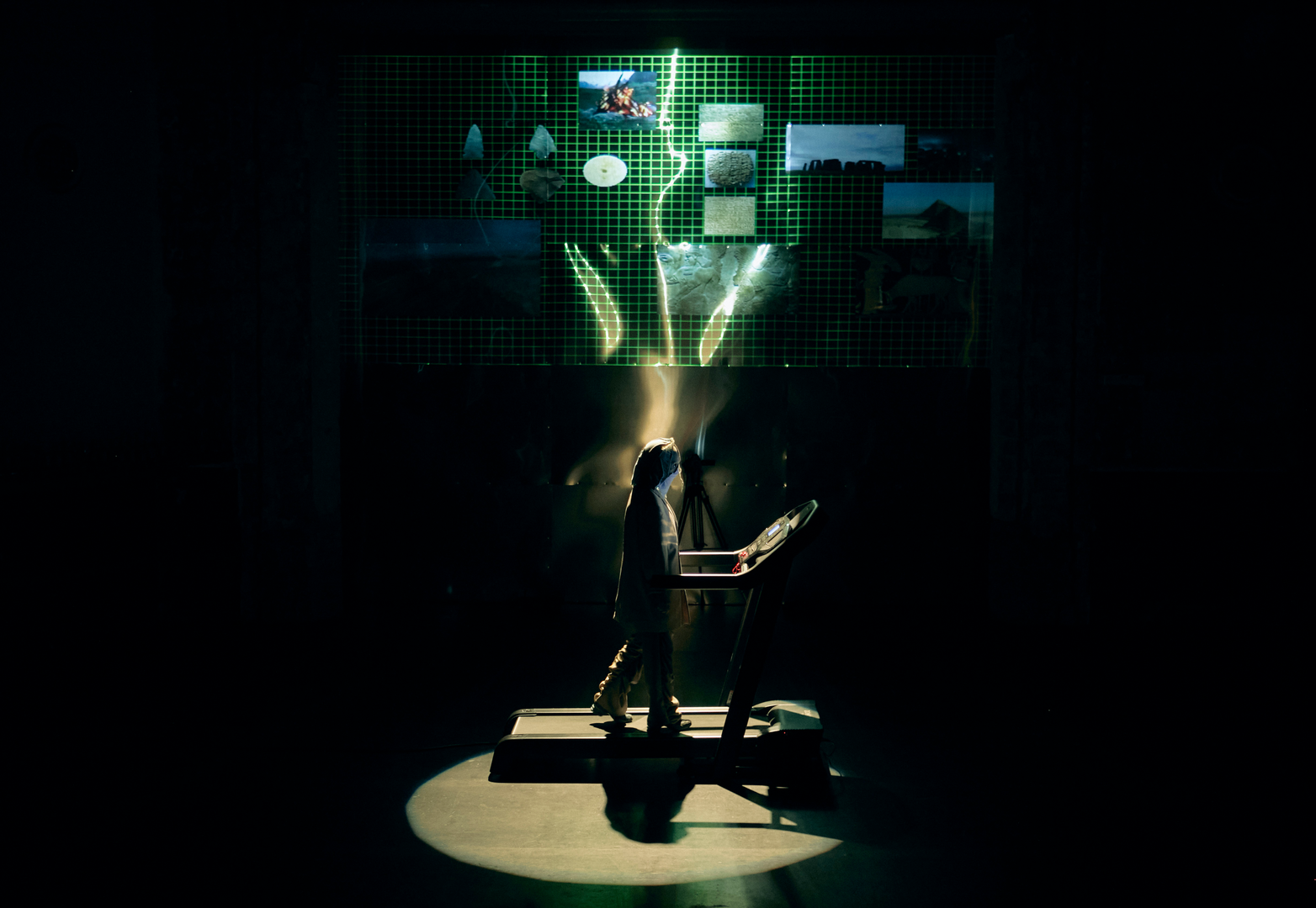 Performer on a treadmill and screen projections